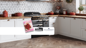 FLBOne Falcon black cooker in a modern kitchen with white cabinets and wooden floors. A dish magazine cover, falcon logo and silverwood bakeware logos sit over top.